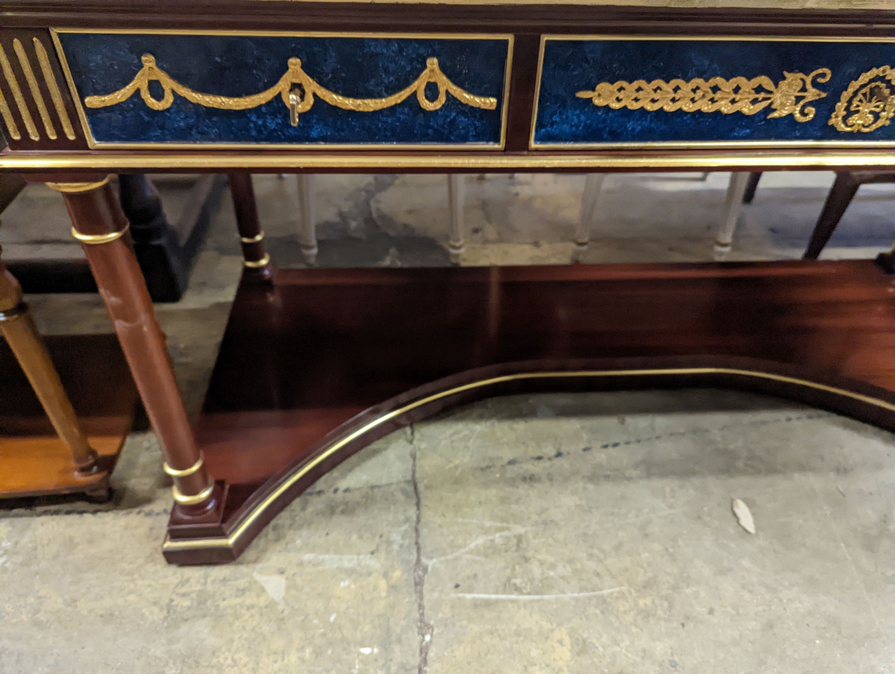 An Empire style parcel gilt and faux malachite marble top console table with concave undertier, width 154cm, depth 65cm, height 80cm